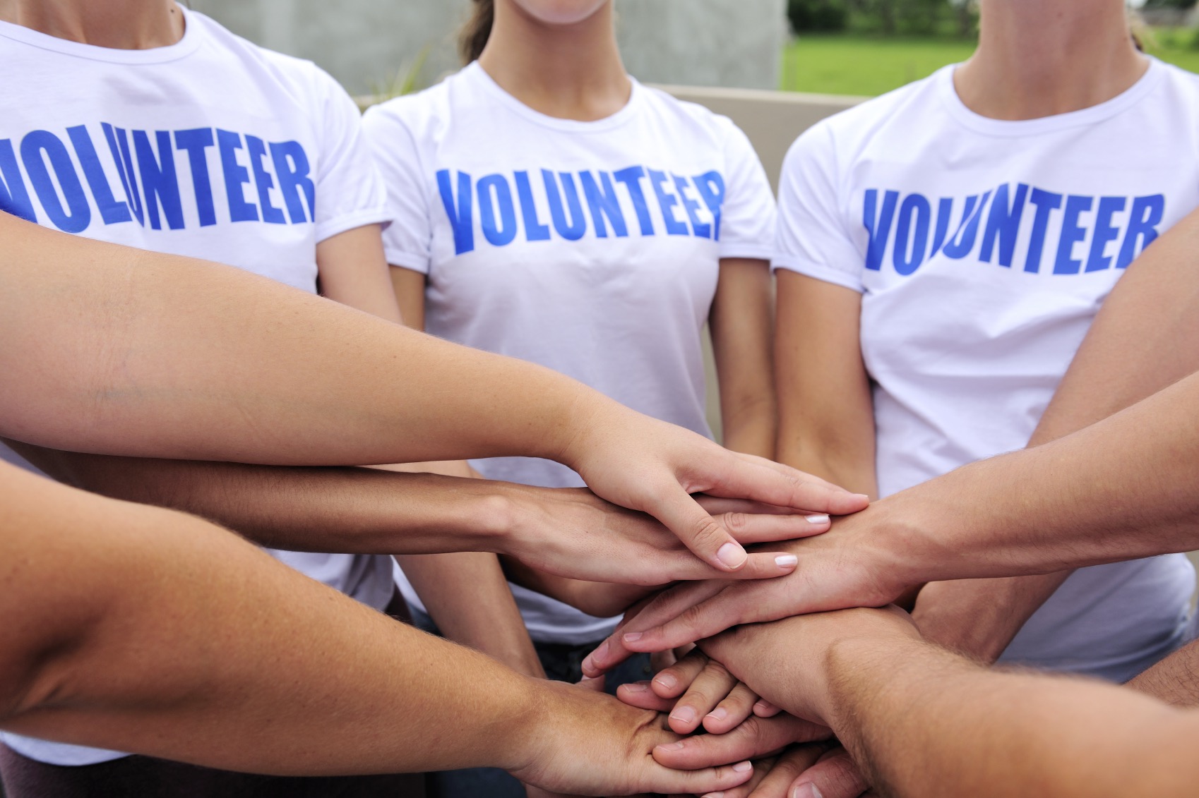 volunteer group hands together showing unity